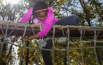 Girl climbing a rope